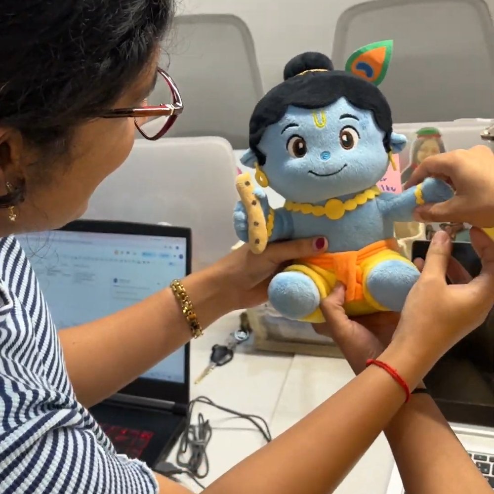 Customer with the Krishna plush at her desk