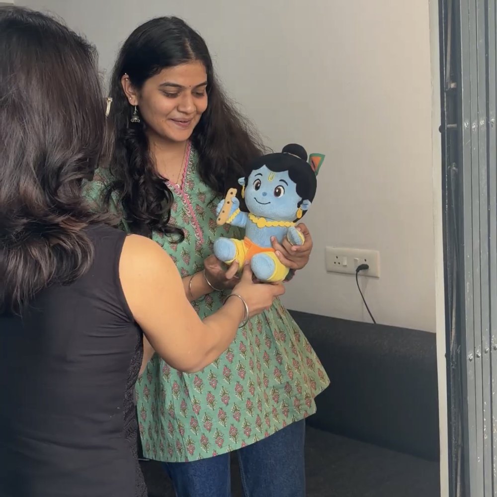 Customer smiling at the Krishna plush